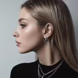 a model with blond hair wearing silver jewelry