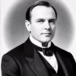 a man with a suit on and bow tie