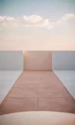 an empty walkway through a white area in the sky