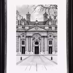 a black and white photograph of a building with two pillars