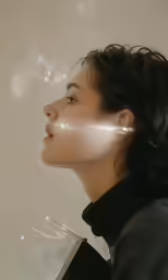 a woman has her face obscured by smoke