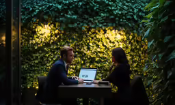 man and woman sitting at a table having a meeting