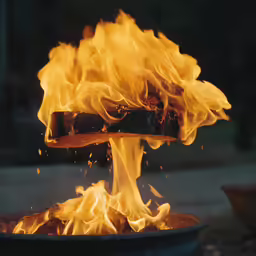 a pot full of fire with flames coming out of it