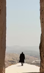 there is a man that is walking on the street