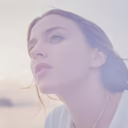 a woman looks up while wearing a necklace