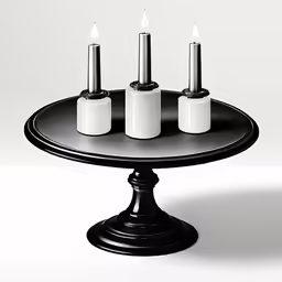 three candles on a black tray sitting on a table