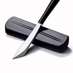 a black handle knife sitting on top of a black object