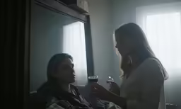 the woman in white is sitting beside the mirror