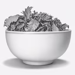 a bowl is filled with leafy vegetables