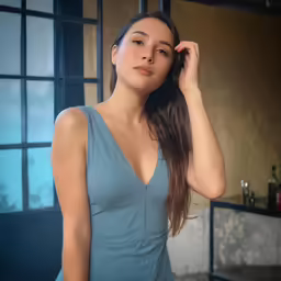 a woman with long hair wearing a blue top