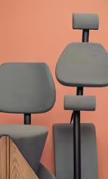 a gray office chair sitting next to a wood table