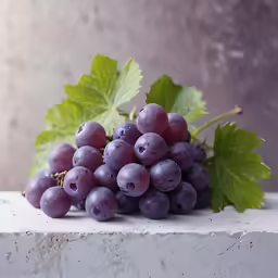 a group of grapes sit on top of a counter