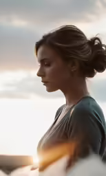 the woman is standing in the field outside with her cell phone
