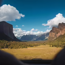the view from a vehicle as it travels through mountains and trees