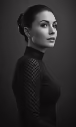 a woman is wearing black and has her head up to her chest