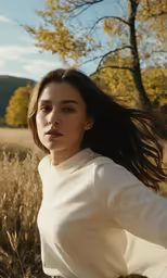 a woman with long hair wearing a white shirt