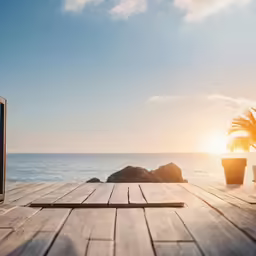 an old tv sitting on a deck in front of the ocean