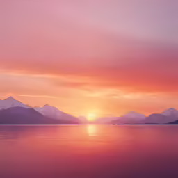 a large body of water surrounded by mountains at sunset
