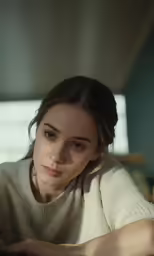 the young woman is looking at her laptop computer