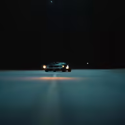 a car driving down a road at night time