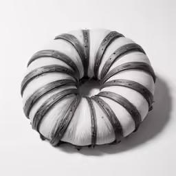 an abstract white and black striped cake on a plate