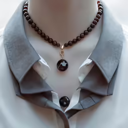 this necklace has a red and black agate pendant