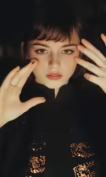 a girl has her hands on her face