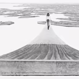 a girl stands on the edge of an over sized slab