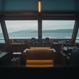 a living room with a chair a couch and two windows