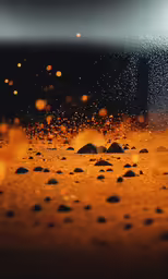 a wet surface with tiny rocks and dirt in front