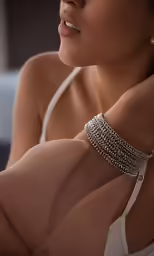 a woman wearing a white bra holding her hands on her hips