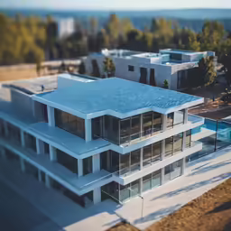 aerial view of an all white house in a beautiful country