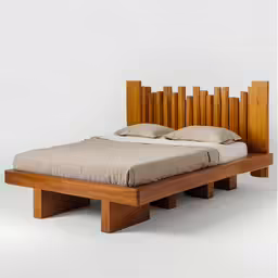 the wooden bed is made up and ready to be slept