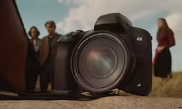 a camera and some people standing by it