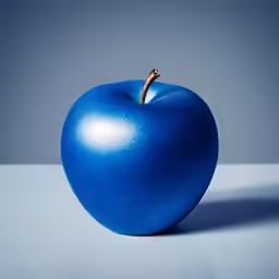 blue apple with a stem sticking out of it