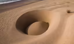 an interesting shaped body of sand on the beach