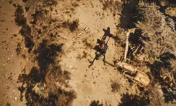 aerial shot of a man in a cowboy hat with a sword on dirt ground
