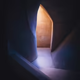 a dimly lit arch between two walls