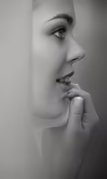 woman in black and white photo of nose and hand