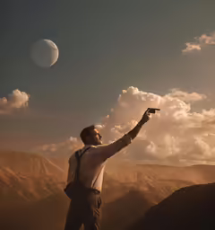 a man with a camera is standing on the mountain