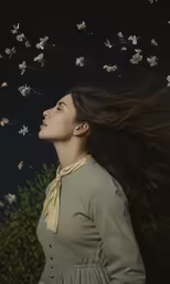 a woman with long hair in a dress blowing the wind