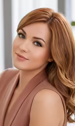 a woman with shoulder length hair and bright brown eyes