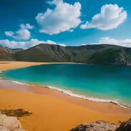 the beach is surrounded by large rocks and beautiful water