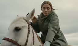 a girl is riding on the back of a horse