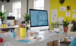 a desktop computer sits in a brightly decorated office