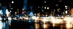 a city street has many buildings, and lights in the night