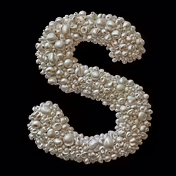 a capital letter made of pearls sits on display