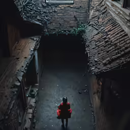woman in a red coat walking down a dark alley