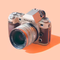 an analog camera on top of a orange background
