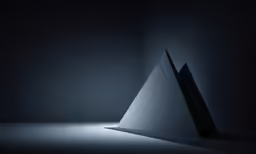 the silhouette of a pyramid sitting in a dark room